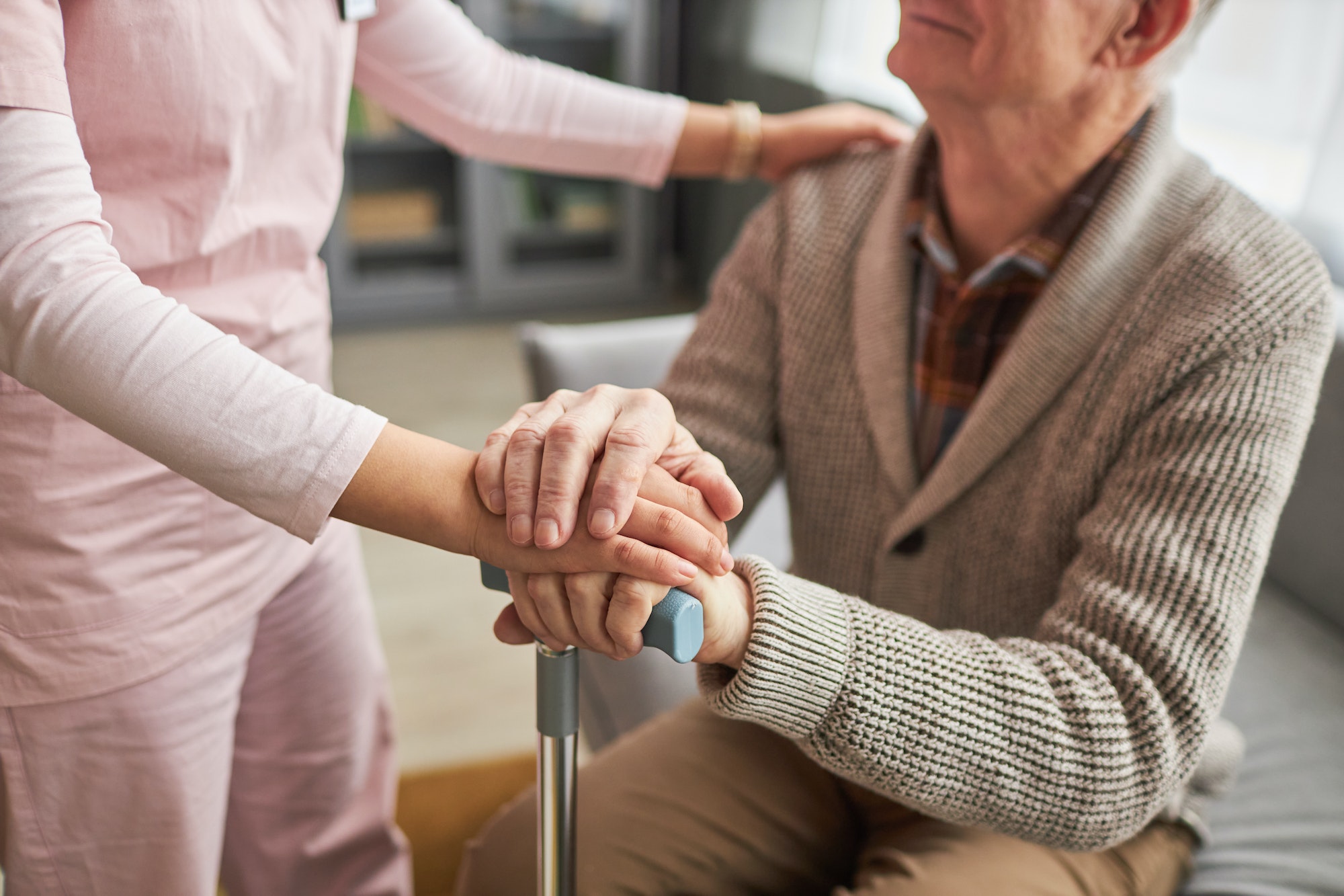 Caregiver caring about elderly man